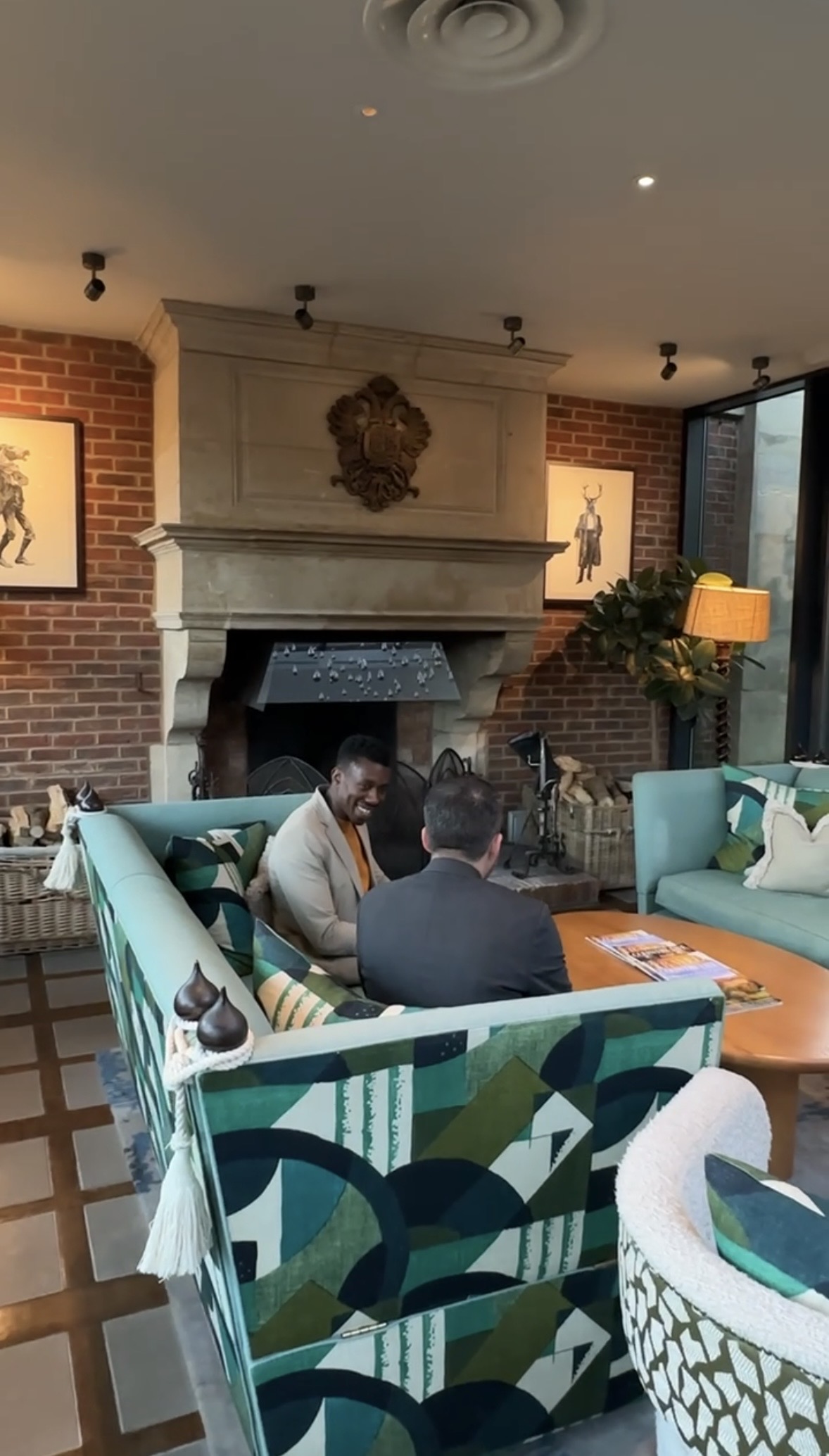 John in conversation by the fireplace